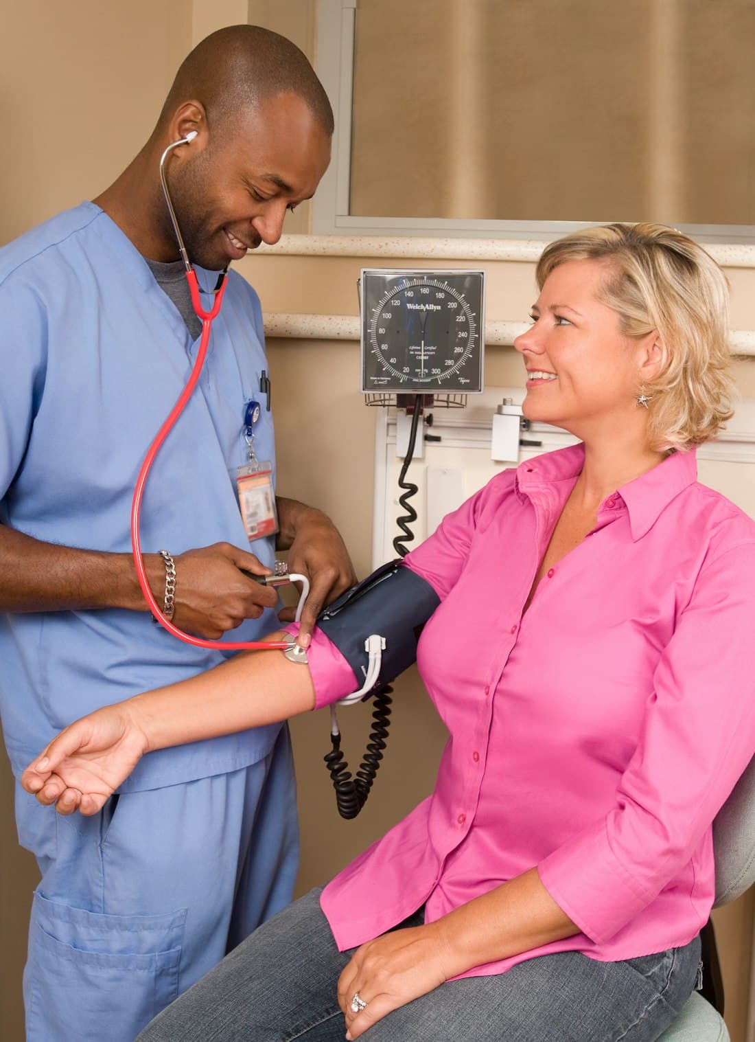 A clinician checking a patient's blood pressure during an office visit